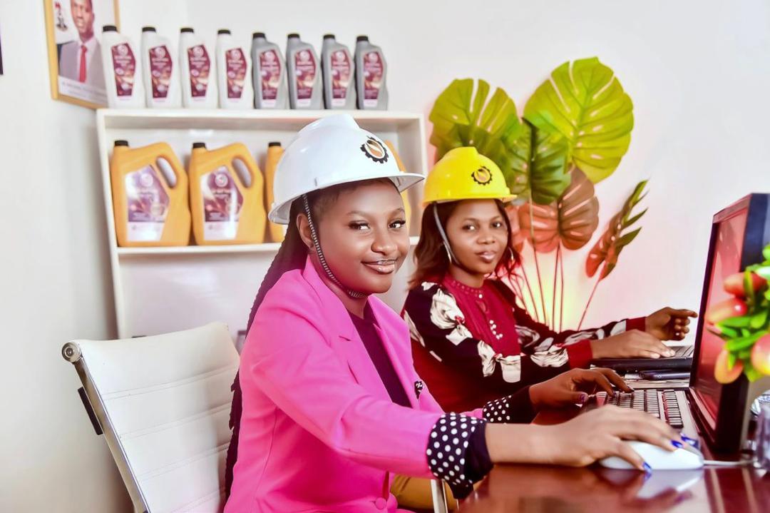 Don Baki staff members wearing safety helmets working on laptops