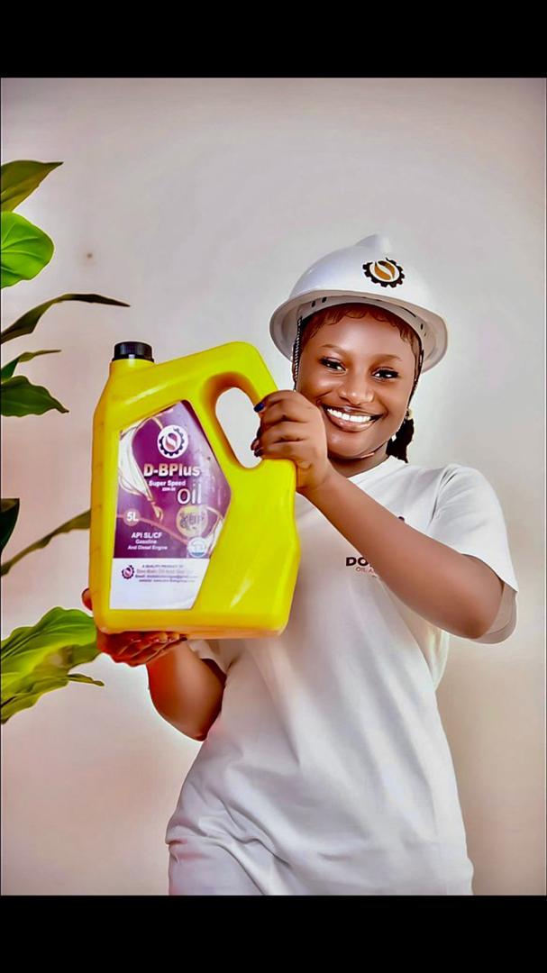 Staff member in safety helmet holding D-BPlus Super Speed Oil
